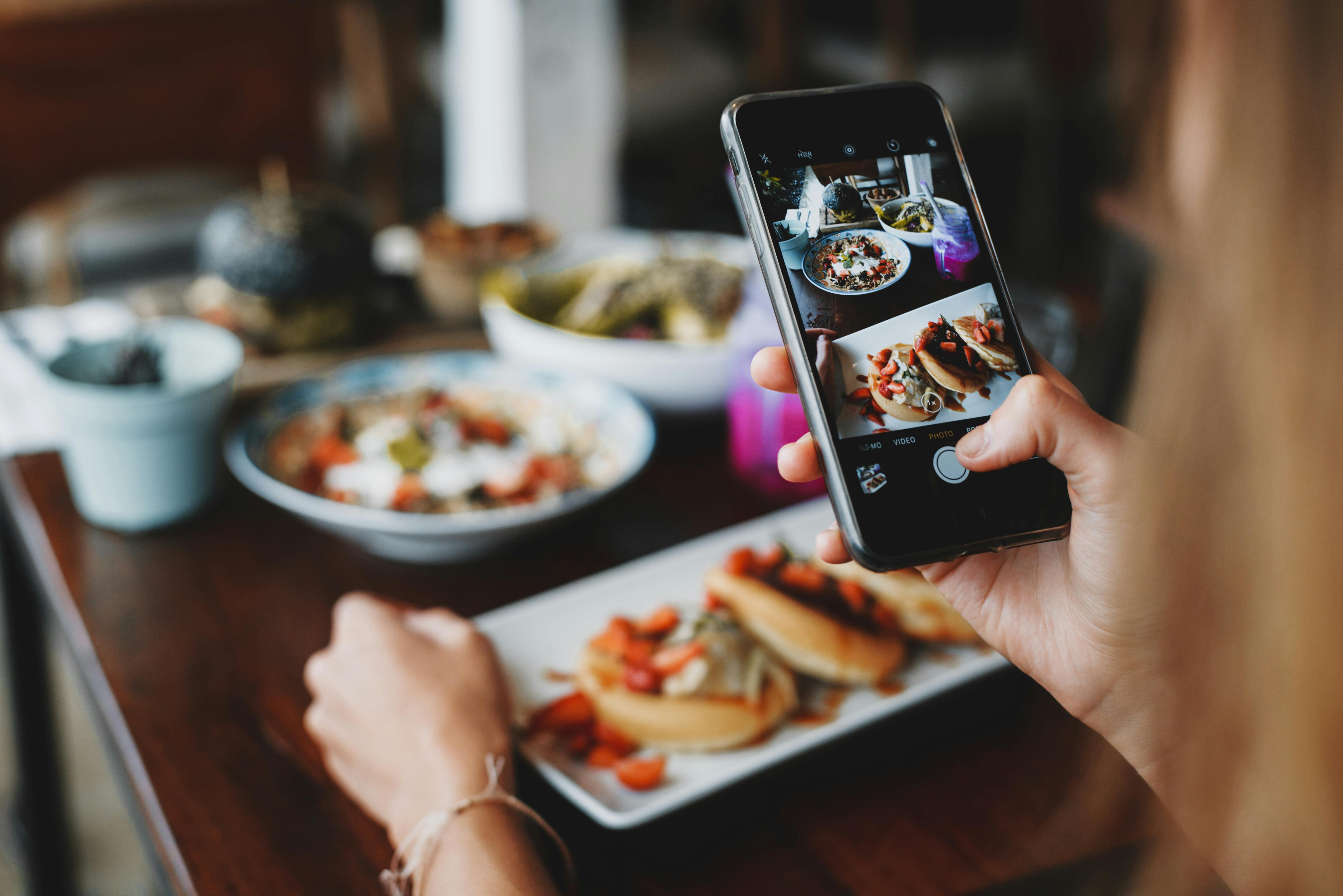 Content creator photographing food for social media